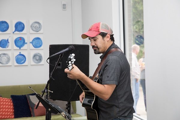 Tauvy Thomason playing the guitar